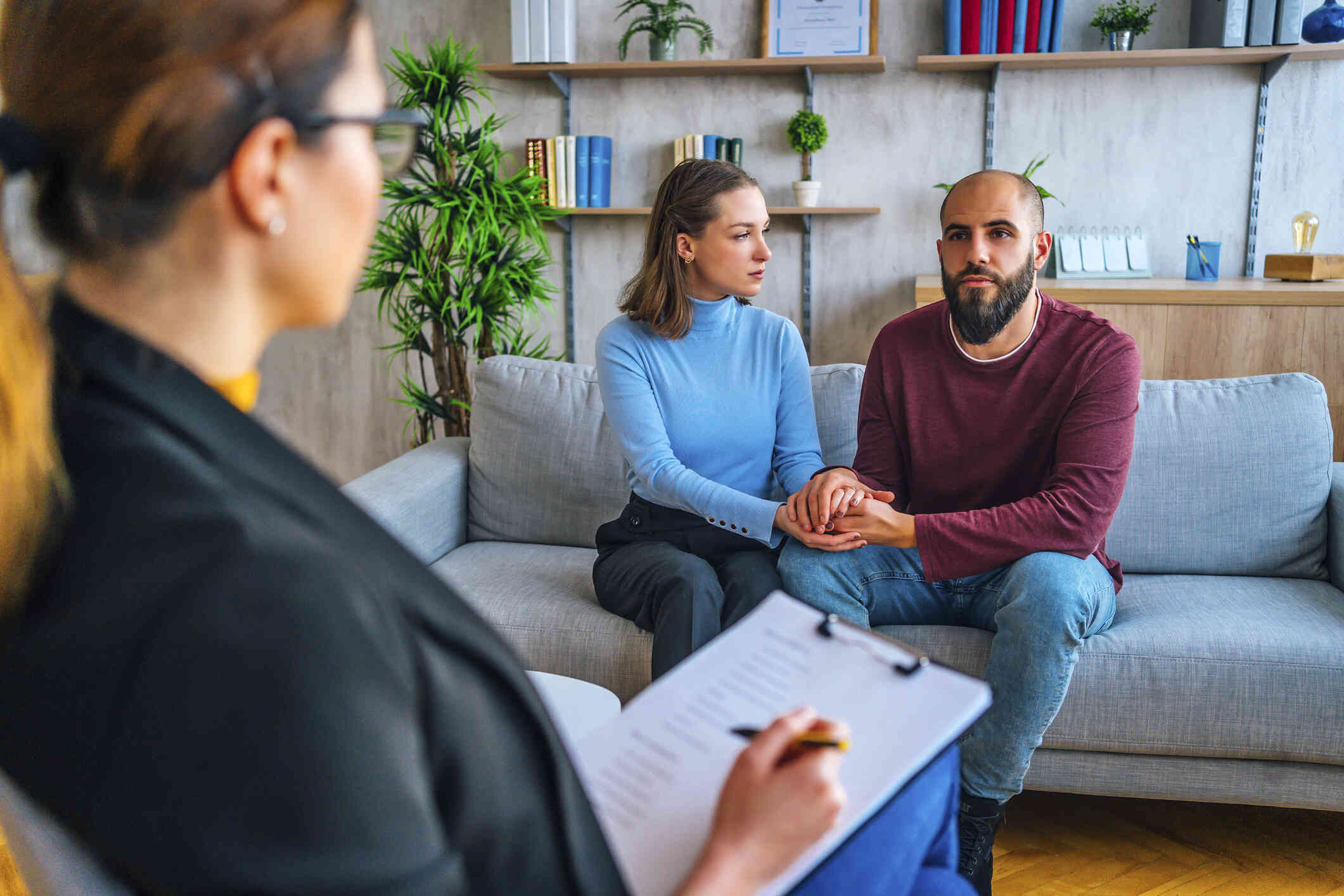 A couple is attending their therapy session while both holding each other’s hand.