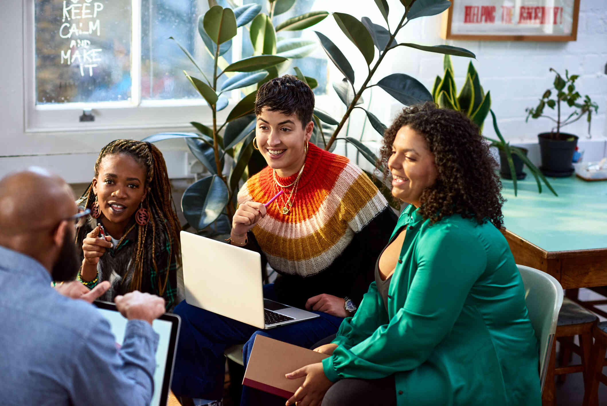 A group of colleagues sitting together and discussing a project. 