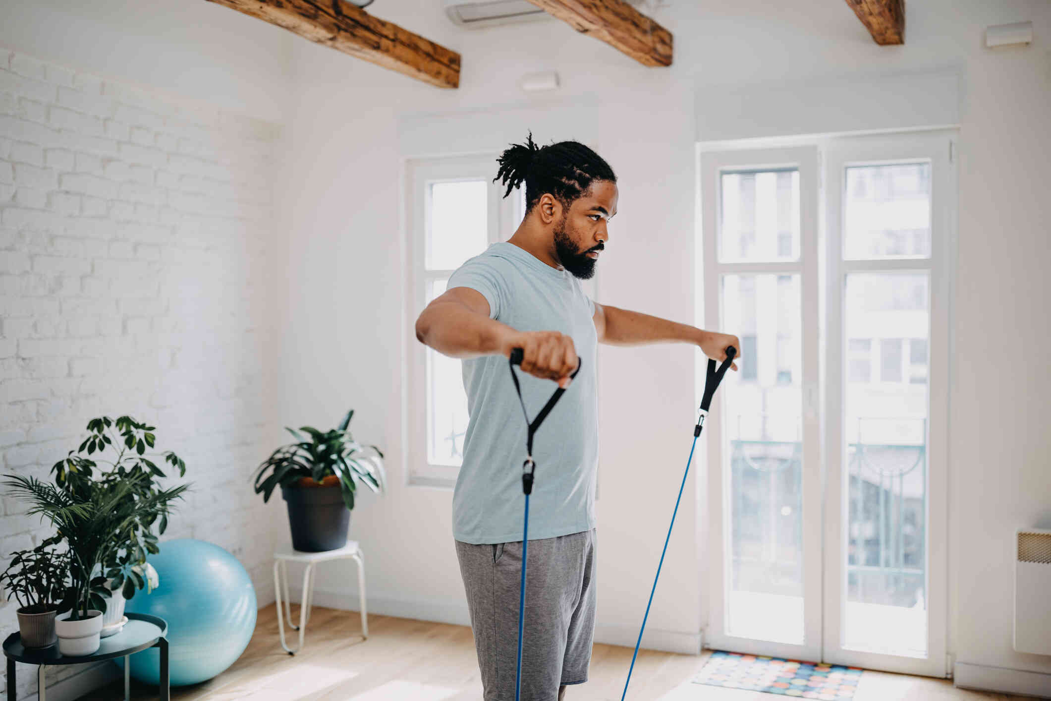 Man exercising indoors, lifting weights.