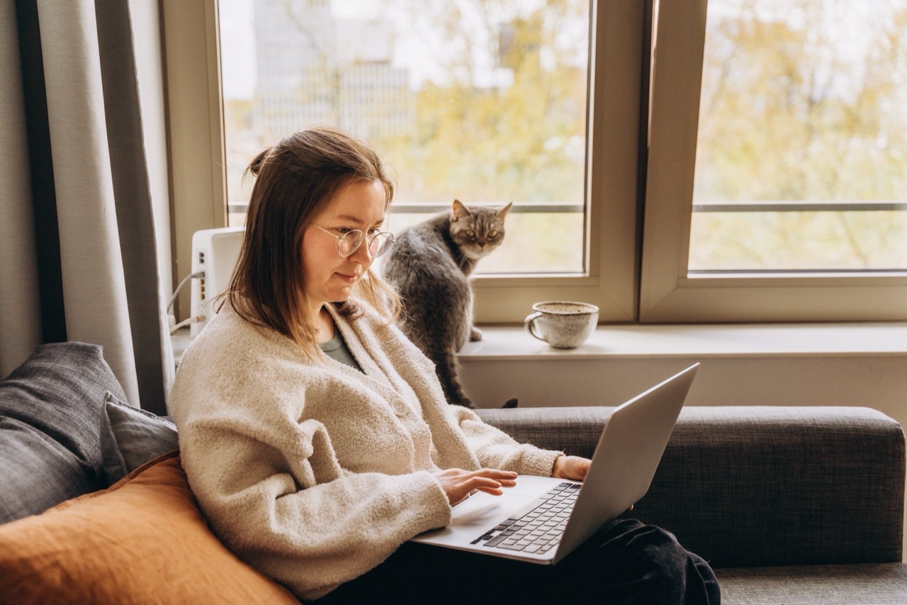 woman with laptop and cat