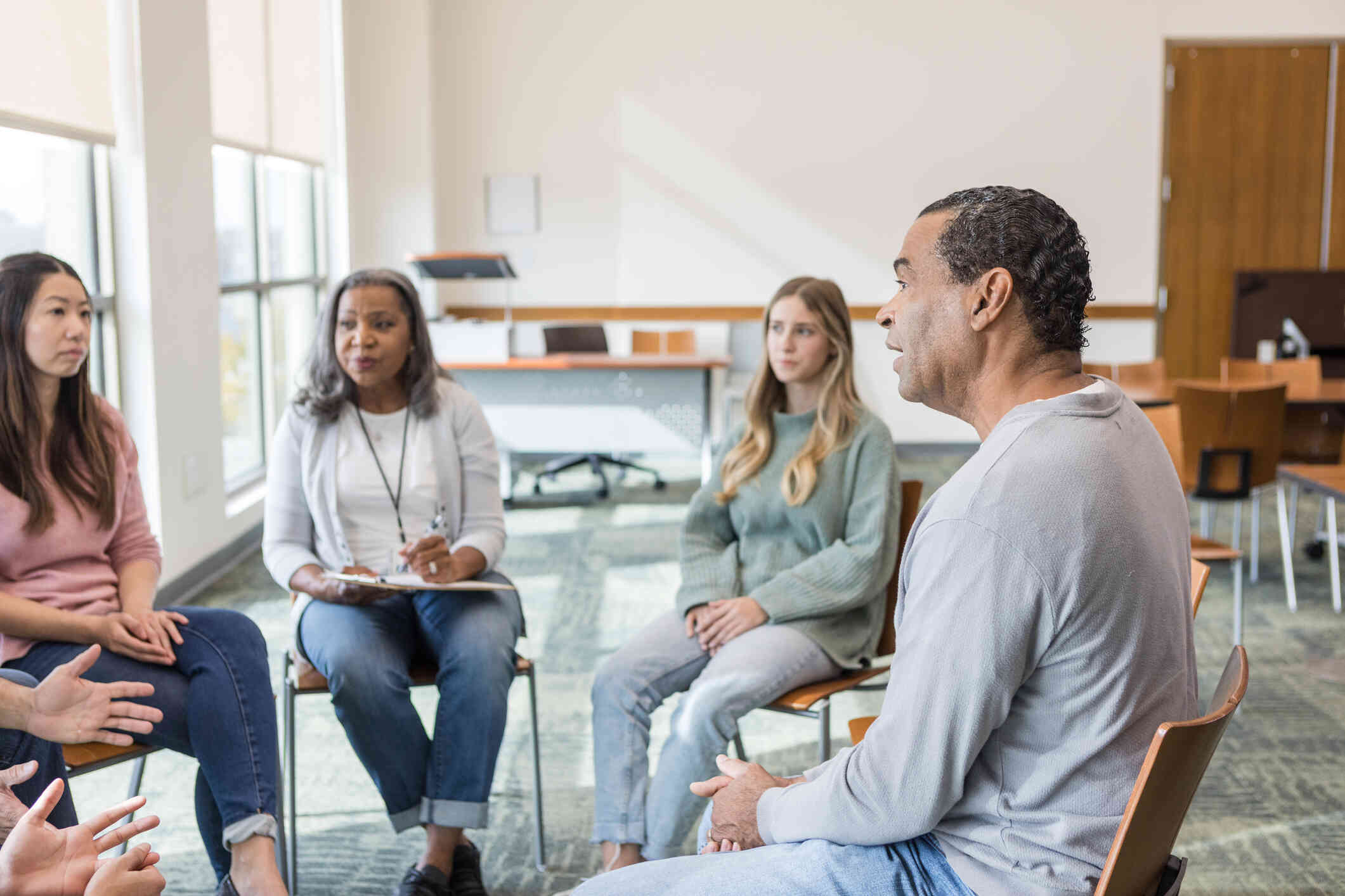 Group sitting together in group session in a indoor room.