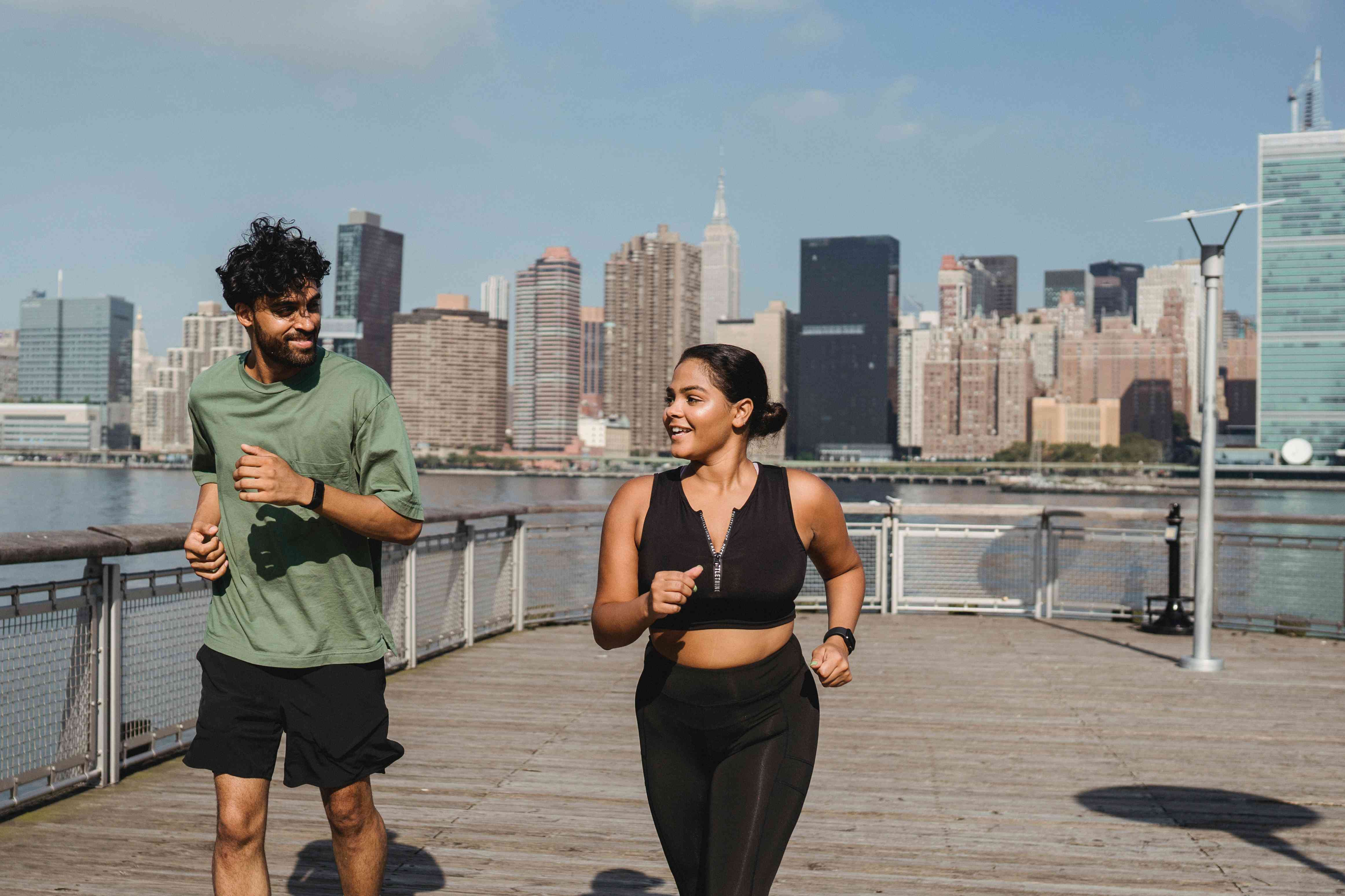 A woman in workout clothes met eye-to-eye with a man while running.